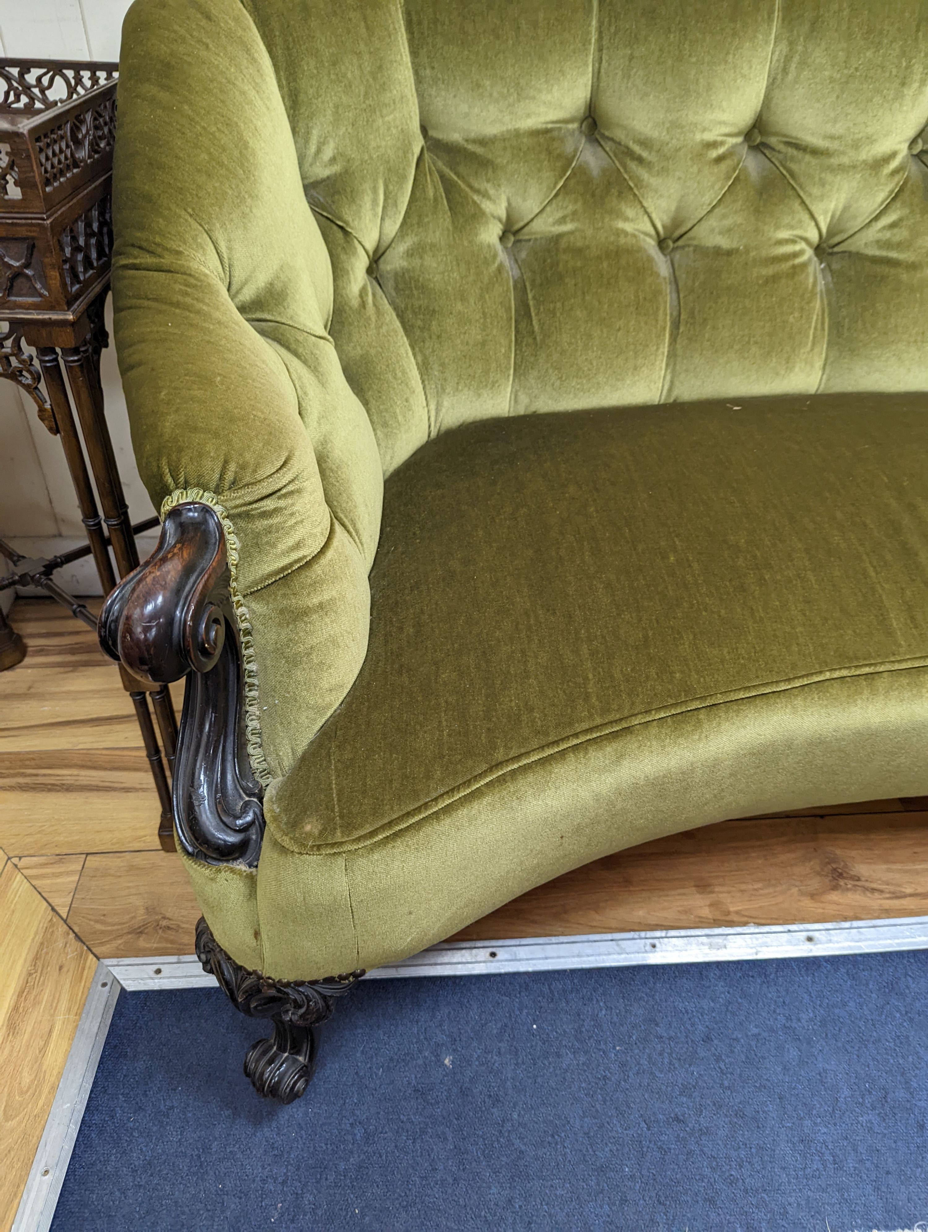 An early Victorian rosewood concave fronted two seat settee upholstered in buttoned green dralon, length 156cm, depth 77cm, height 80cm